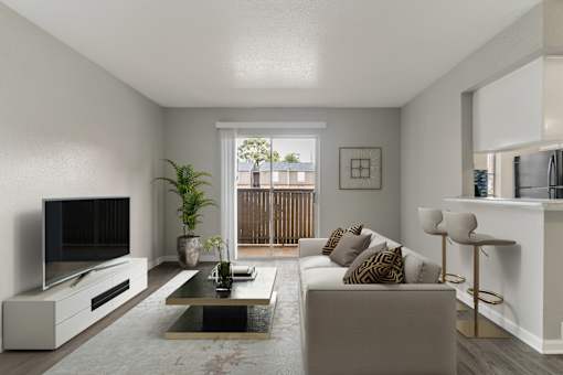 A modern living room with a white sofa, a coffee table, and a television.