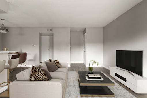 A modern living room with a white sofa, a coffee table, and a television.