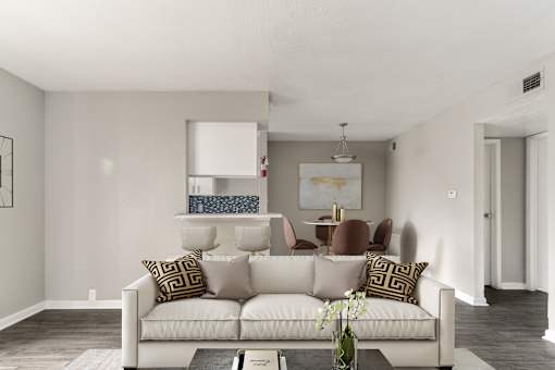 A living room with a white couch and a coffee table.