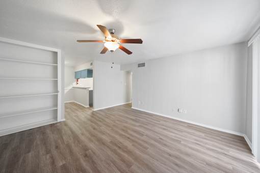 A room with a ceiling fan and light fixture.