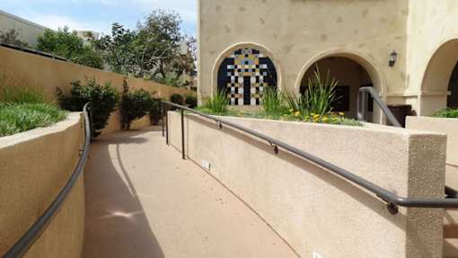 A building with a mosaic tile arched window.