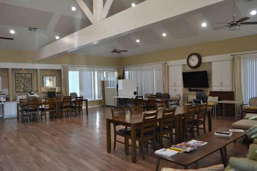A spacious living room with a large wooden table and chairs.