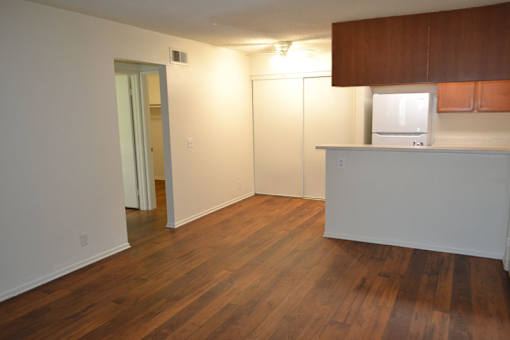 A room with wooden floors and white walls.