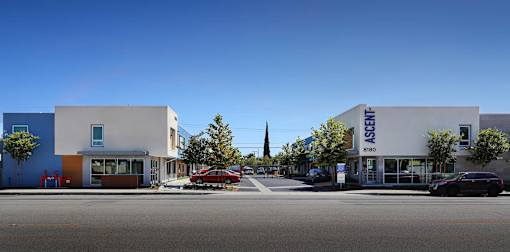 A street view of a building with the word "ASIENT" on it.