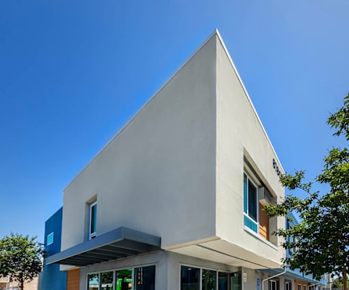 A modern building with a white facade and large windows.