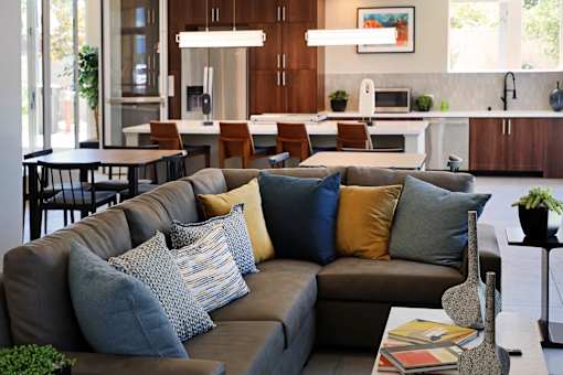 A living room with a grey couch and a coffee table.