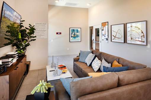 A living room with a brown couch and a coffee table.