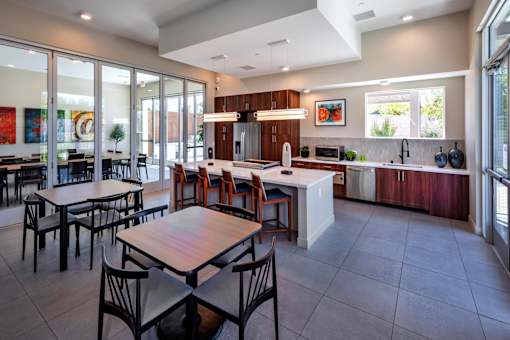 A modern kitchen with a dining table and chairs.