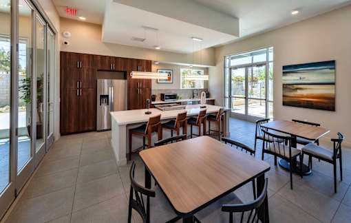 A modern kitchen with a dining table and chairs.
