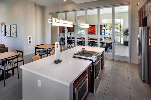 A kitchen with a white counter top and stainless steel appliances.