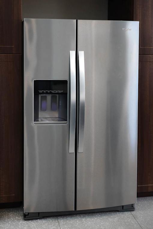 A stainless steel refrigerator with its door open.