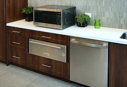 A modern kitchen with a microwave, oven, and dishwasher.