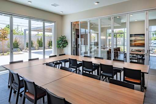A conference room with a long table and chairs.