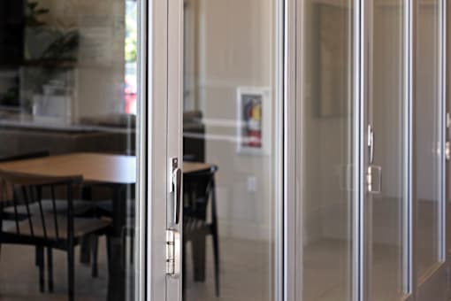 A glass door with a handle is open.