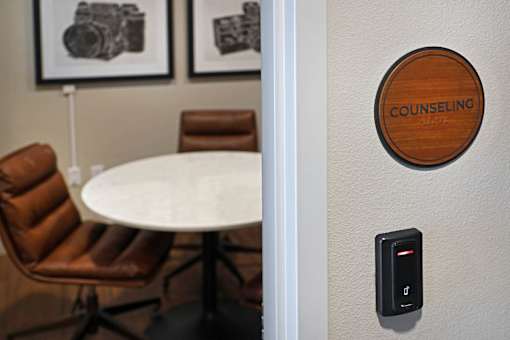A room with a table and chairs and a sign that says counseling.