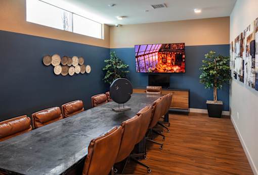 A conference room with a long table and chairs.