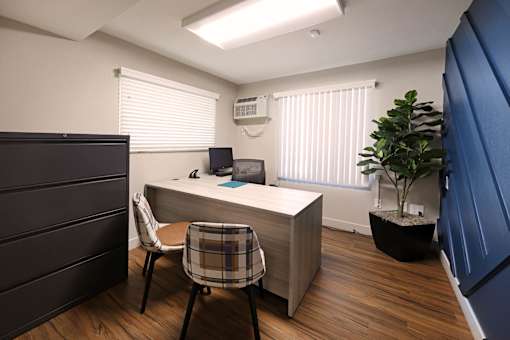 A room with a desk and a chair.