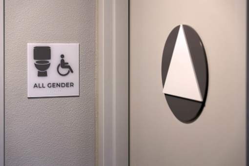 A sign on a door indicating a gender-neutral bathroom.