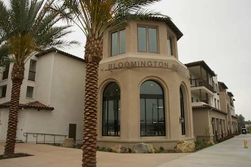 A building with a palm tree in front of it.