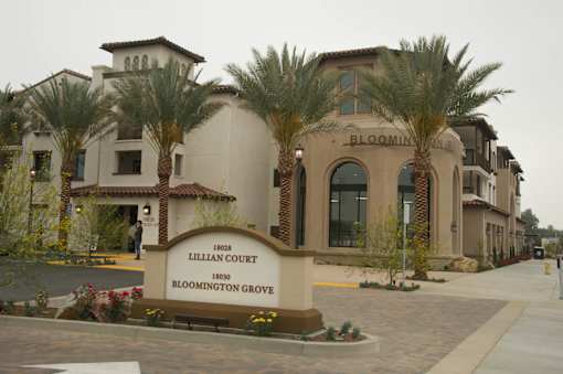 A sign in front of a building that says Lillian Court Bloomington Grove.
