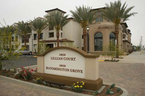 A sign for Lillian Court in Bloomington Grove stands in front of a building.