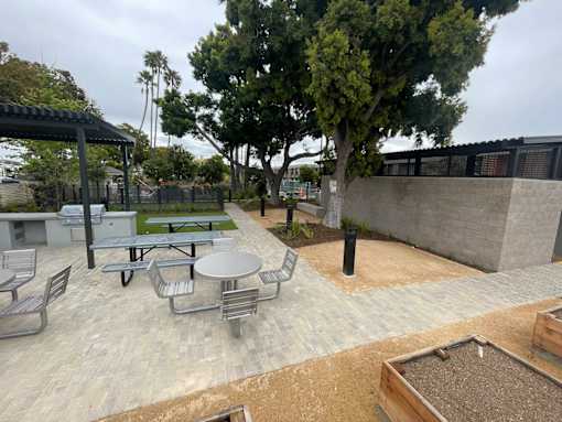 A patio with a table and chairs and a tree.