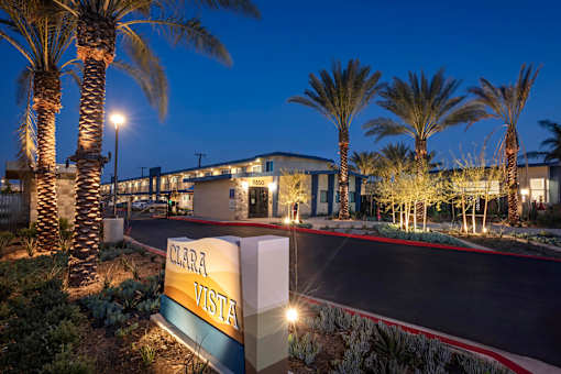 The entrance to the Clara Vista building is lit up at night.