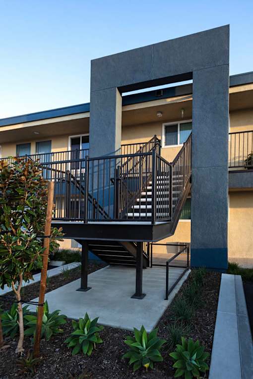 A modern house with a black metal staircase.