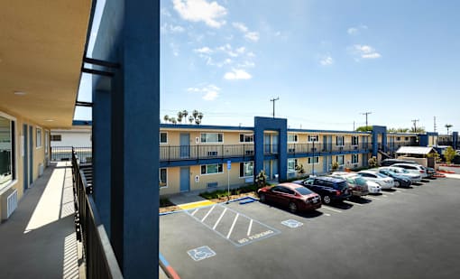 A parking lot with a blue building in the background.