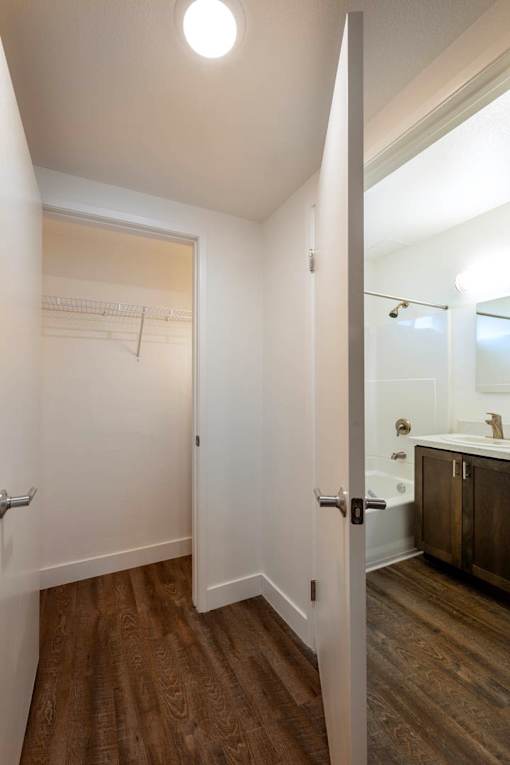 A white door is open to a bathroom.
