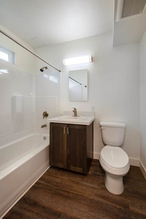 A white toilet sits next to a sink in a bathroom.