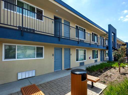 A building with blue trim and a balcony.