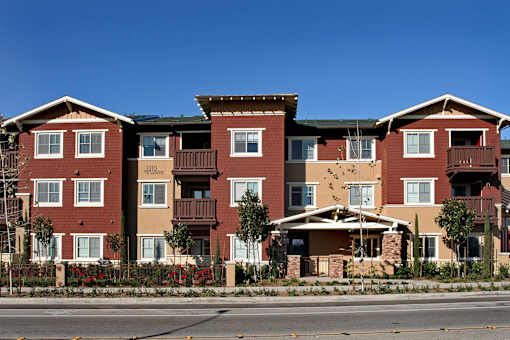 Apartment building with red brick and white trim.