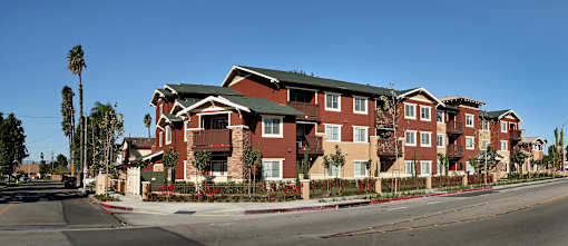 Apartment building with red brick and green roofs.