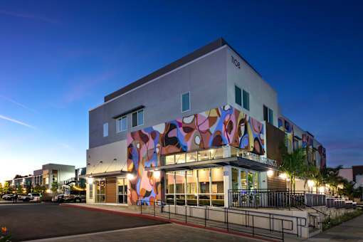 A modern building with a colorful mural on the side.