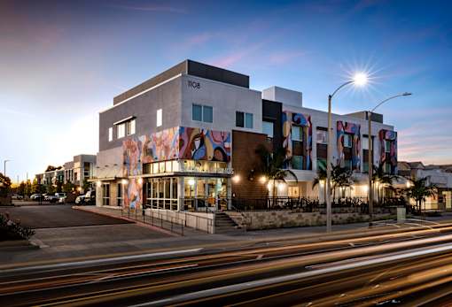 A modern building with a colorful mural on the side.