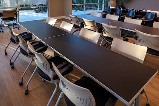 A conference room with a long table and chairs.
