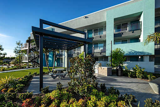 A modern building with a large open area in front.