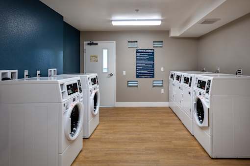 A row of washing machines in a laundromat.