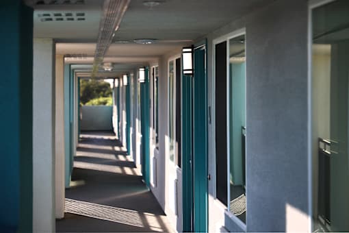 A long corridor with doors on both sides.
