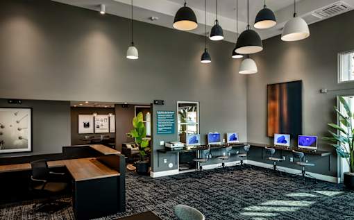 A modern office space with computers and desks.