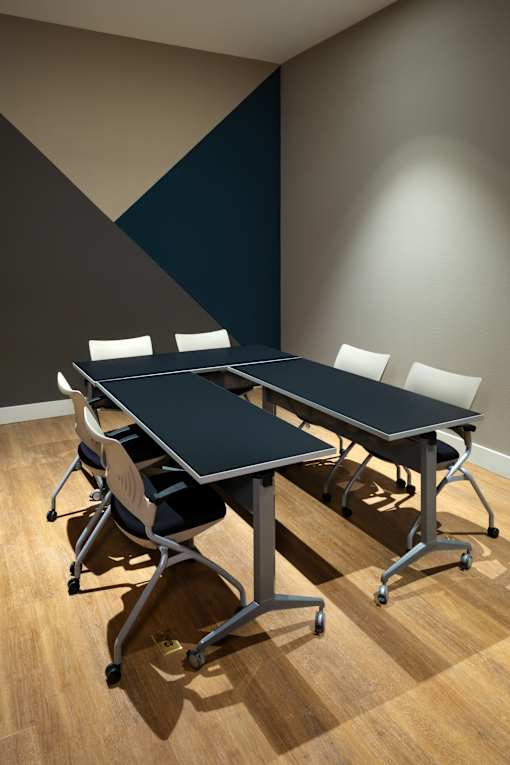 A conference room with a table and chairs.
