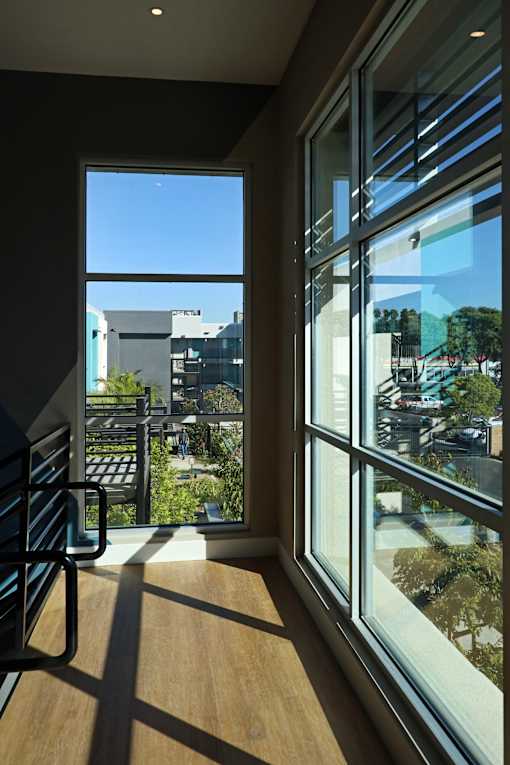 A room with a view of the city through large windows.