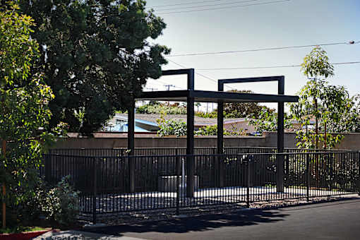 A black metal gate with a decorative arch above it.