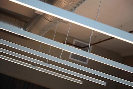 A series of white lines are suspended from the ceiling.