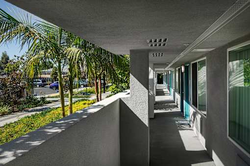 A long, narrow walkway with a concrete ceiling and walls.
