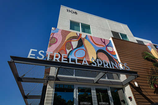 The sign on the building reads "ESTRELLA SPRINGS".