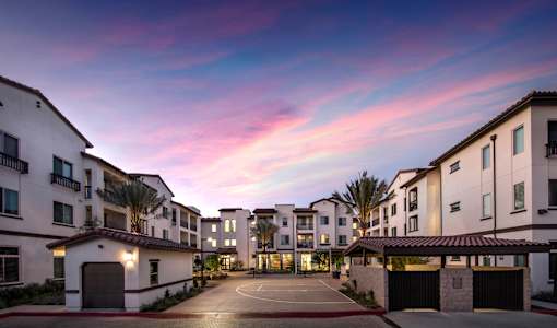 A residential area with apartment buildings and a driveway.