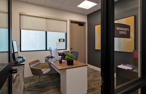 A sign on a door reads "Manager's Office".