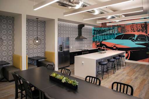A modern dining area with a black table and chairs.